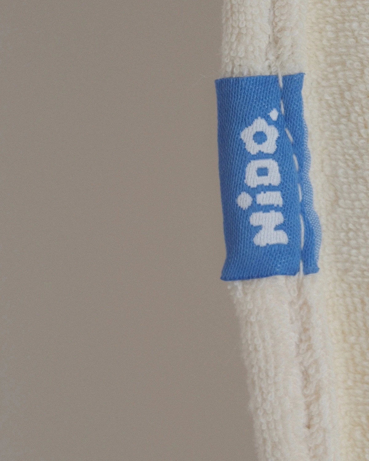 The genuine blue woven Nido label on the bound edge