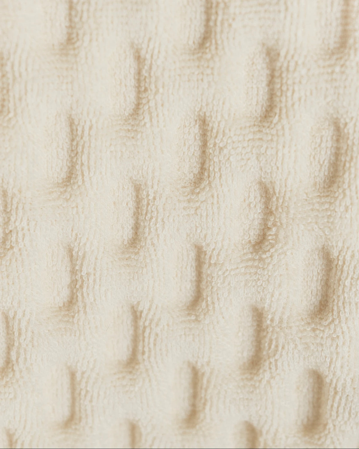 Close-up of Nido’s cream textile and dimples